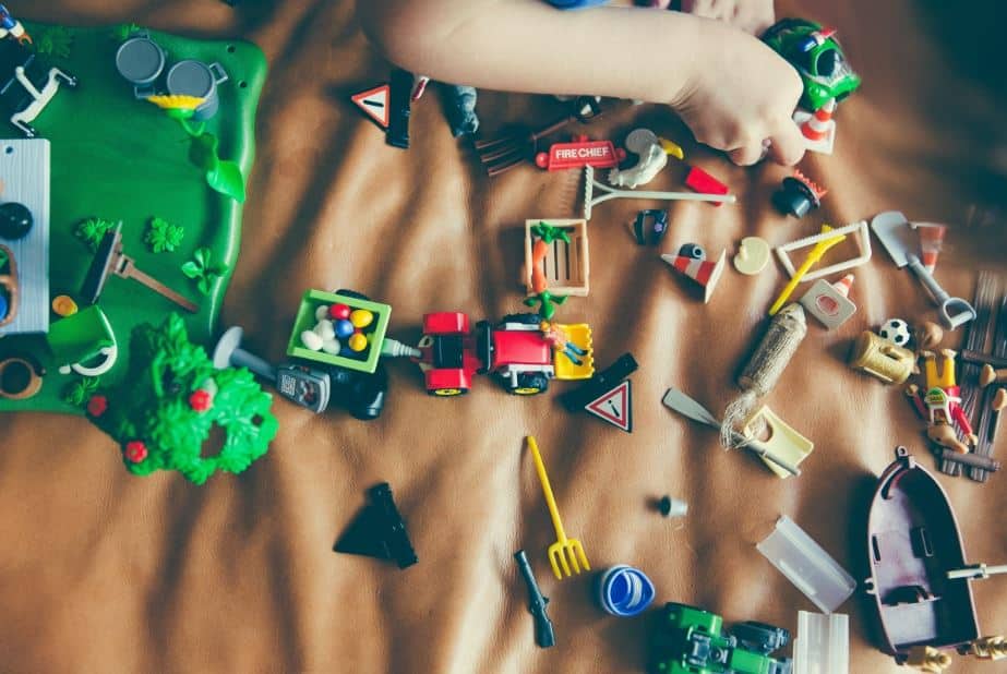 Petit garçon qui joue avec ses jouets et ses petites voitures